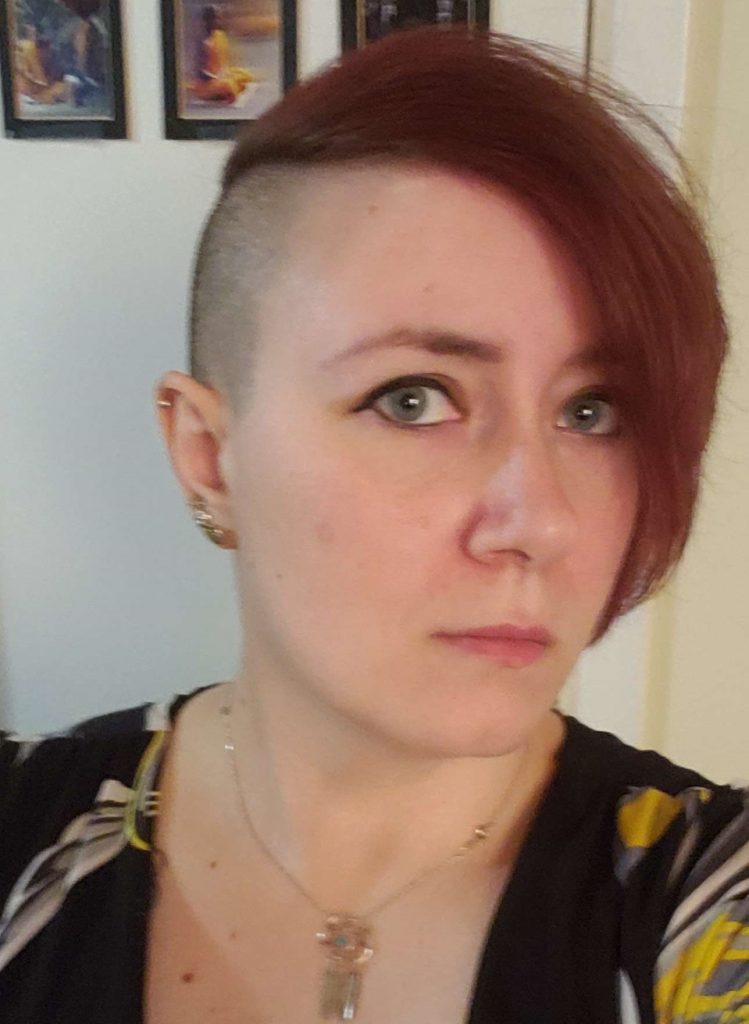 a person with red hair looking at the camera